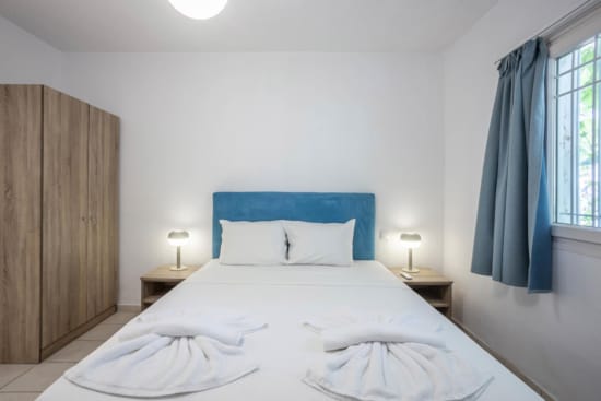 a bed with a blue curtain