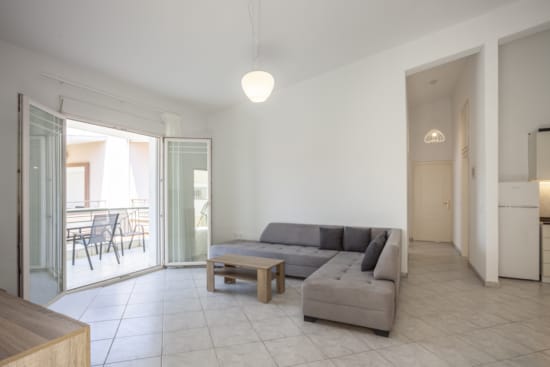 a living room with a couch and chairs