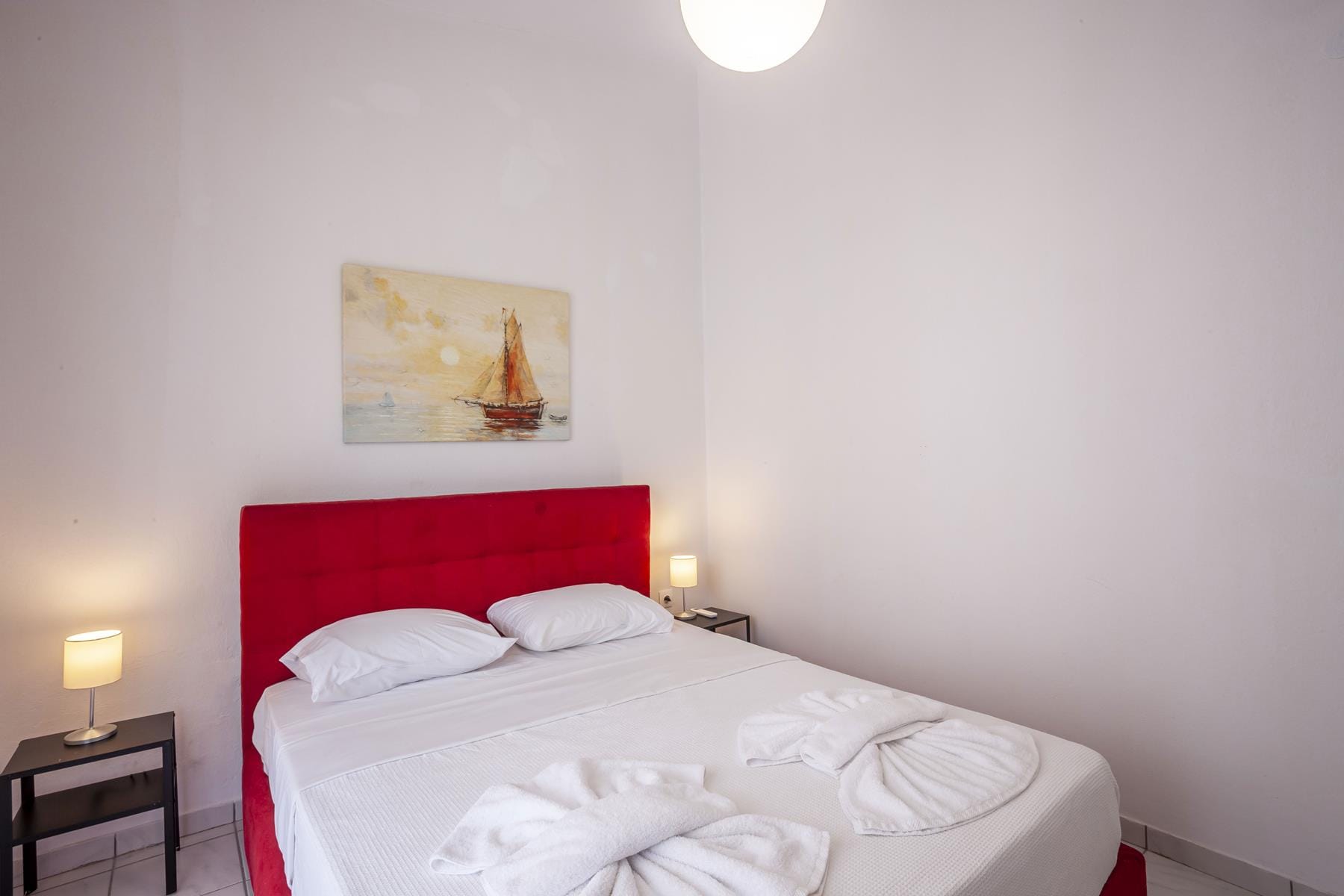 a bed with a red headboard