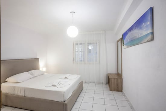 a room with a bed and a painting on the wall