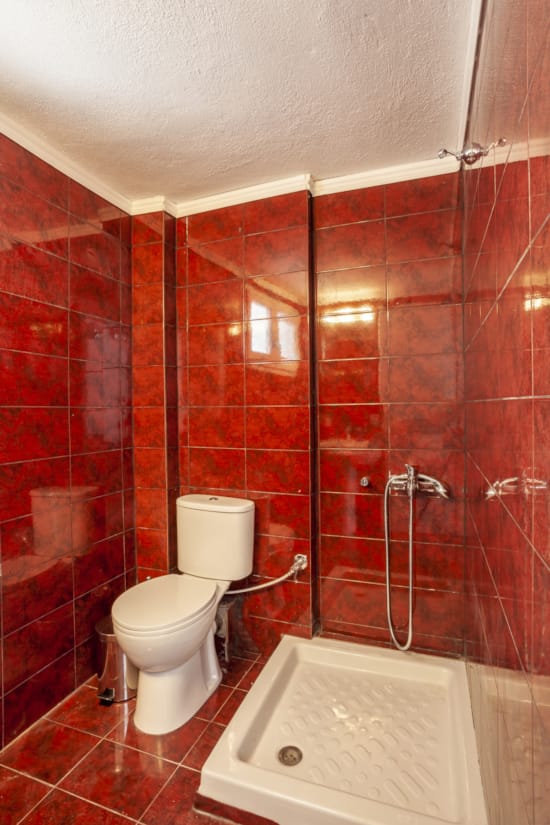 a bathroom with a toilet and shower