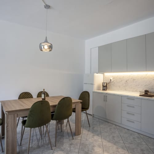 a kitchen with a table and chairs