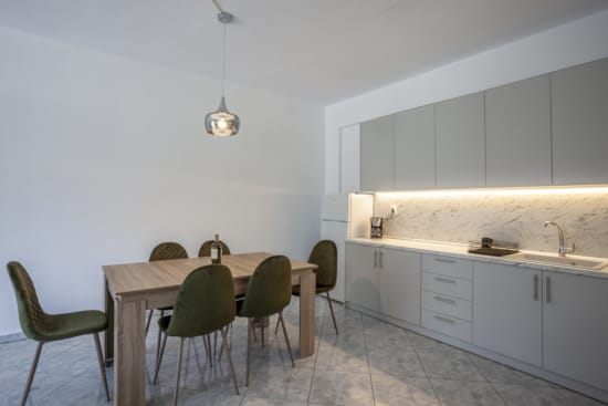 a kitchen with a table and chairs