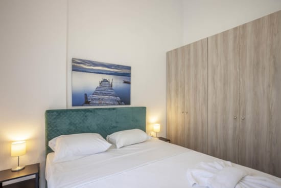 a bed with a painting on the wall