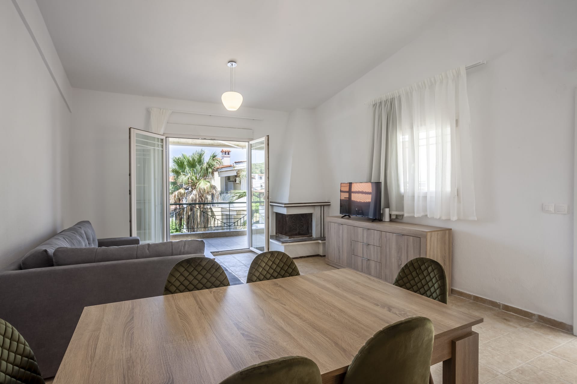 a living room with a table and couches