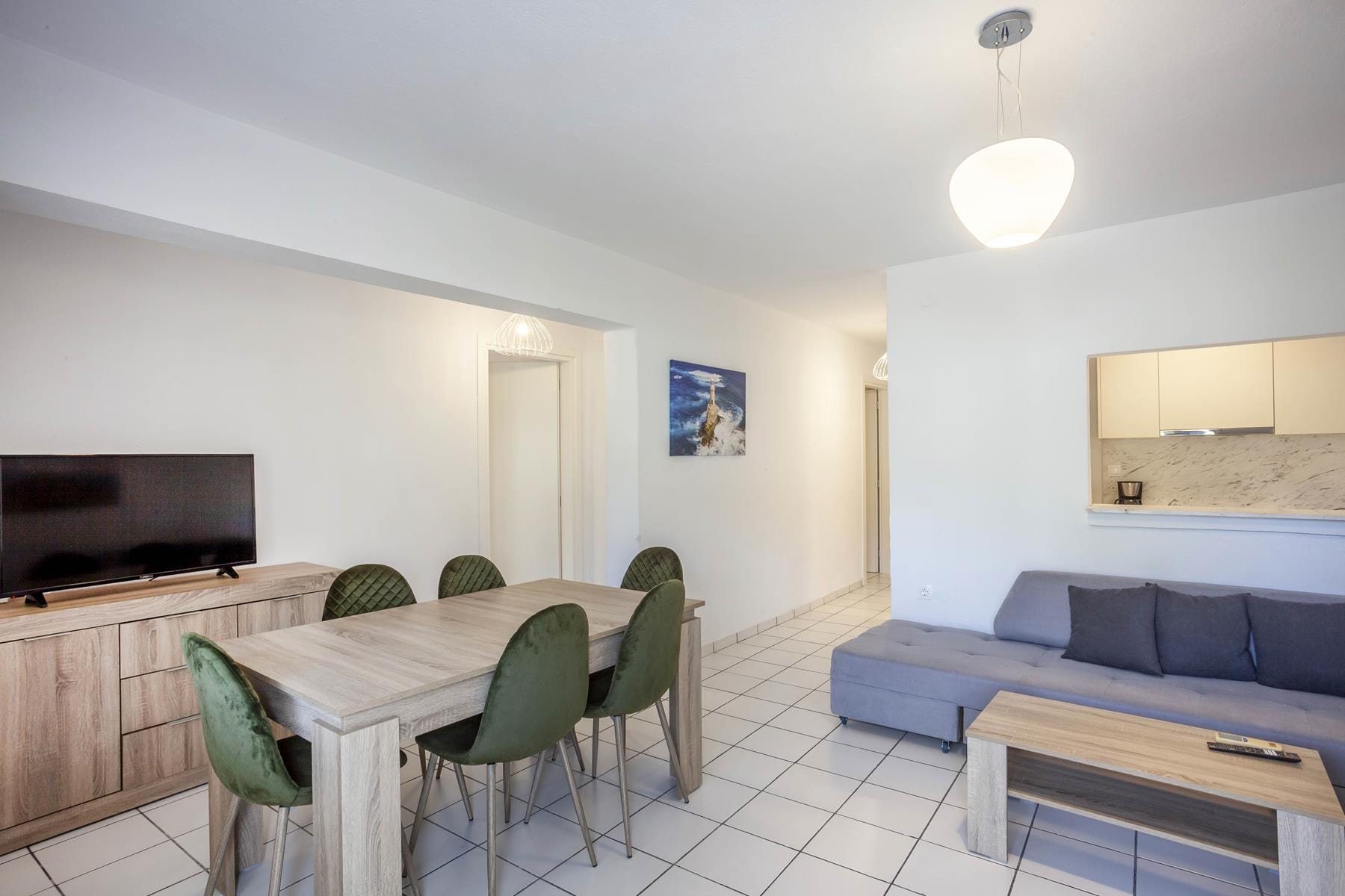 a room with a couch and chairs