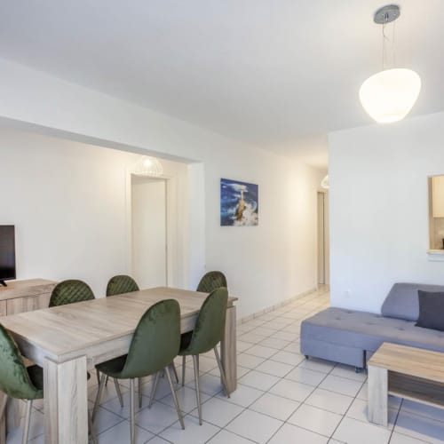 a room with a couch and chairs