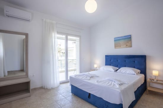 a bedroom with a bed and a mirror