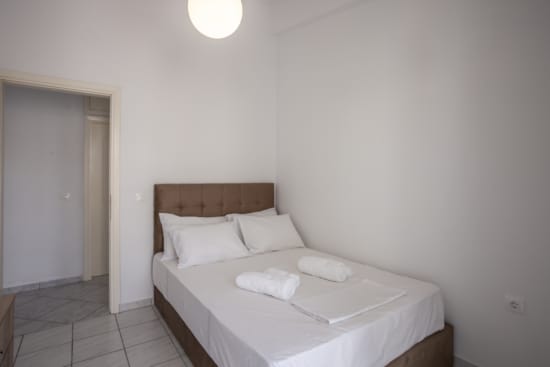 a bed with white sheets and pillows