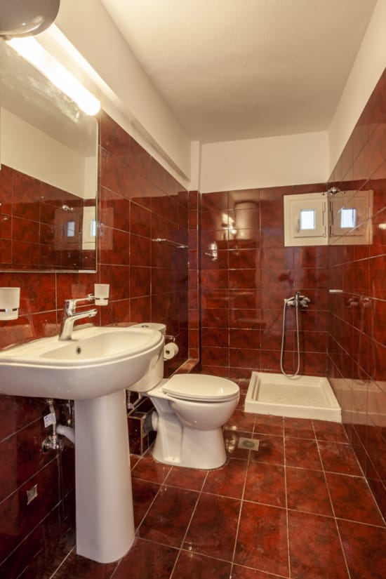 a bathroom with a sink toilet and a mirror