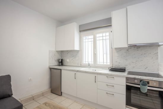a kitchen with white cabinets