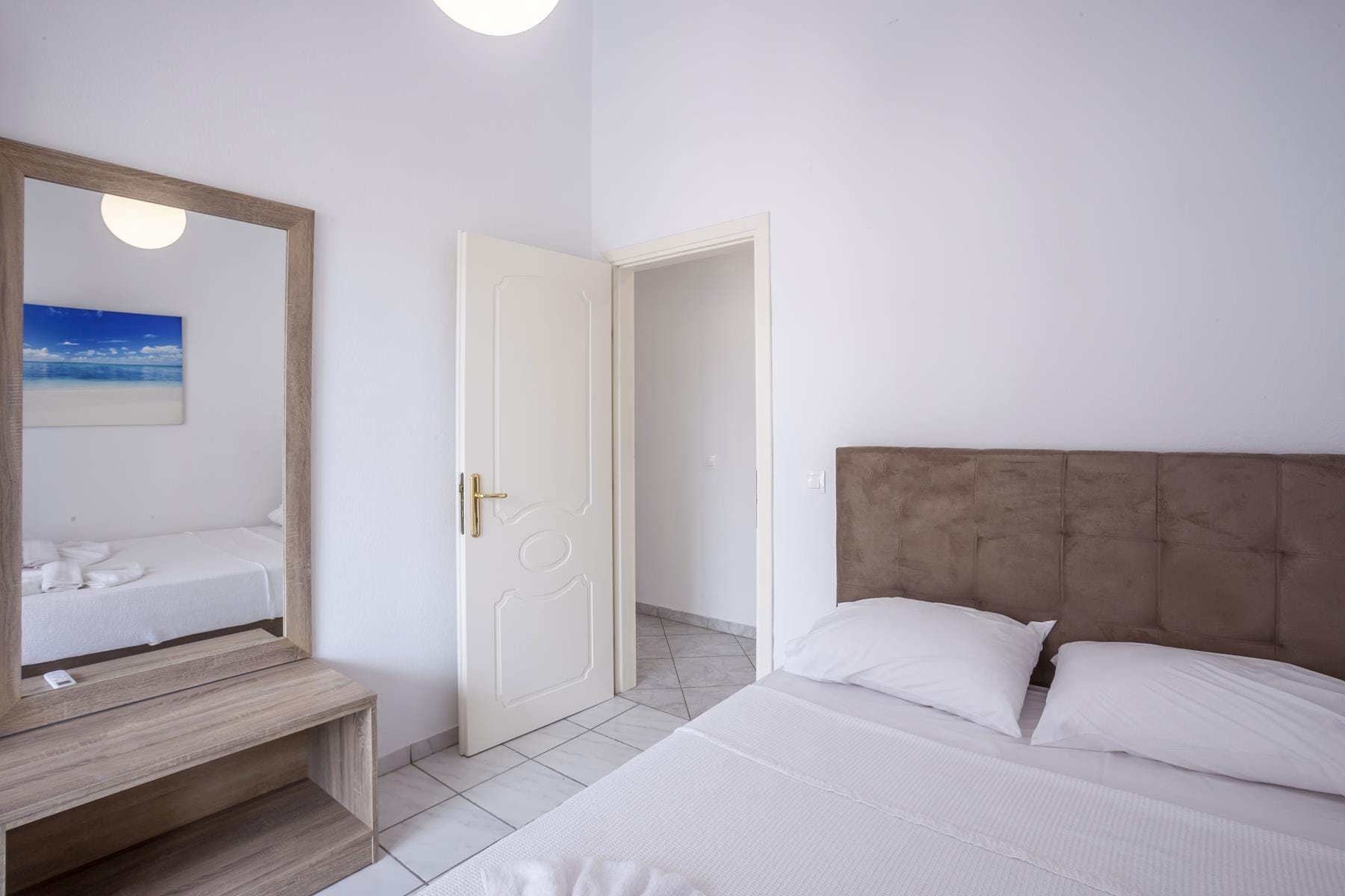 a room with a bed and a mirror