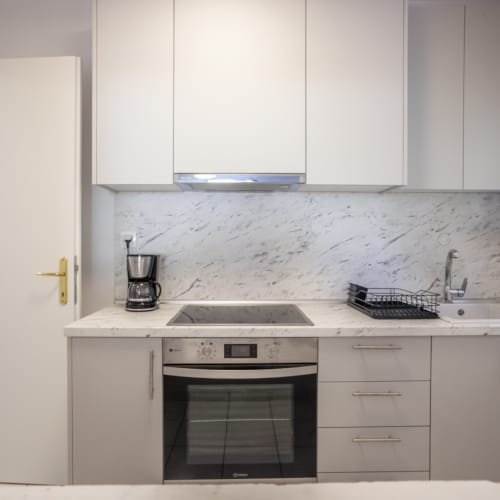 a kitchen with white cabinets