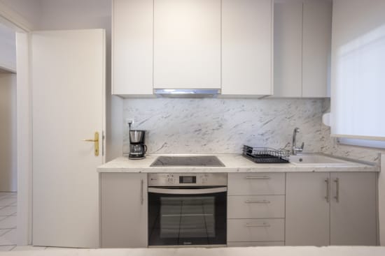 a kitchen with white cabinets
