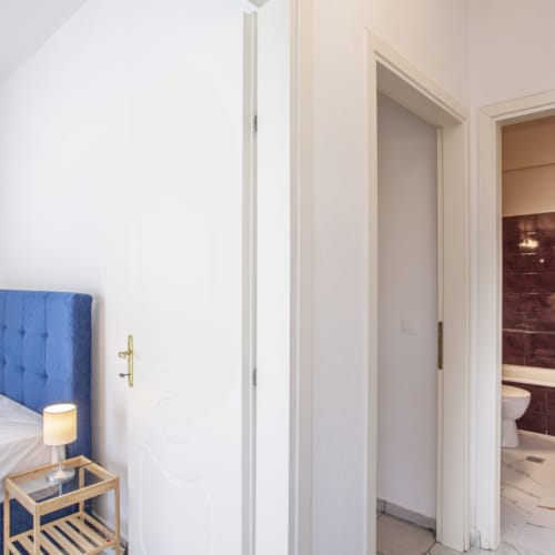 a bathroom with a bed and a small bed