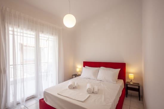 a bed with white sheets and pillows