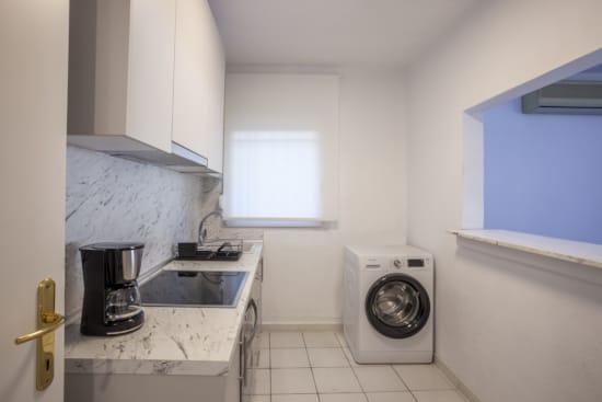 a small kitchen with a washer and dryer