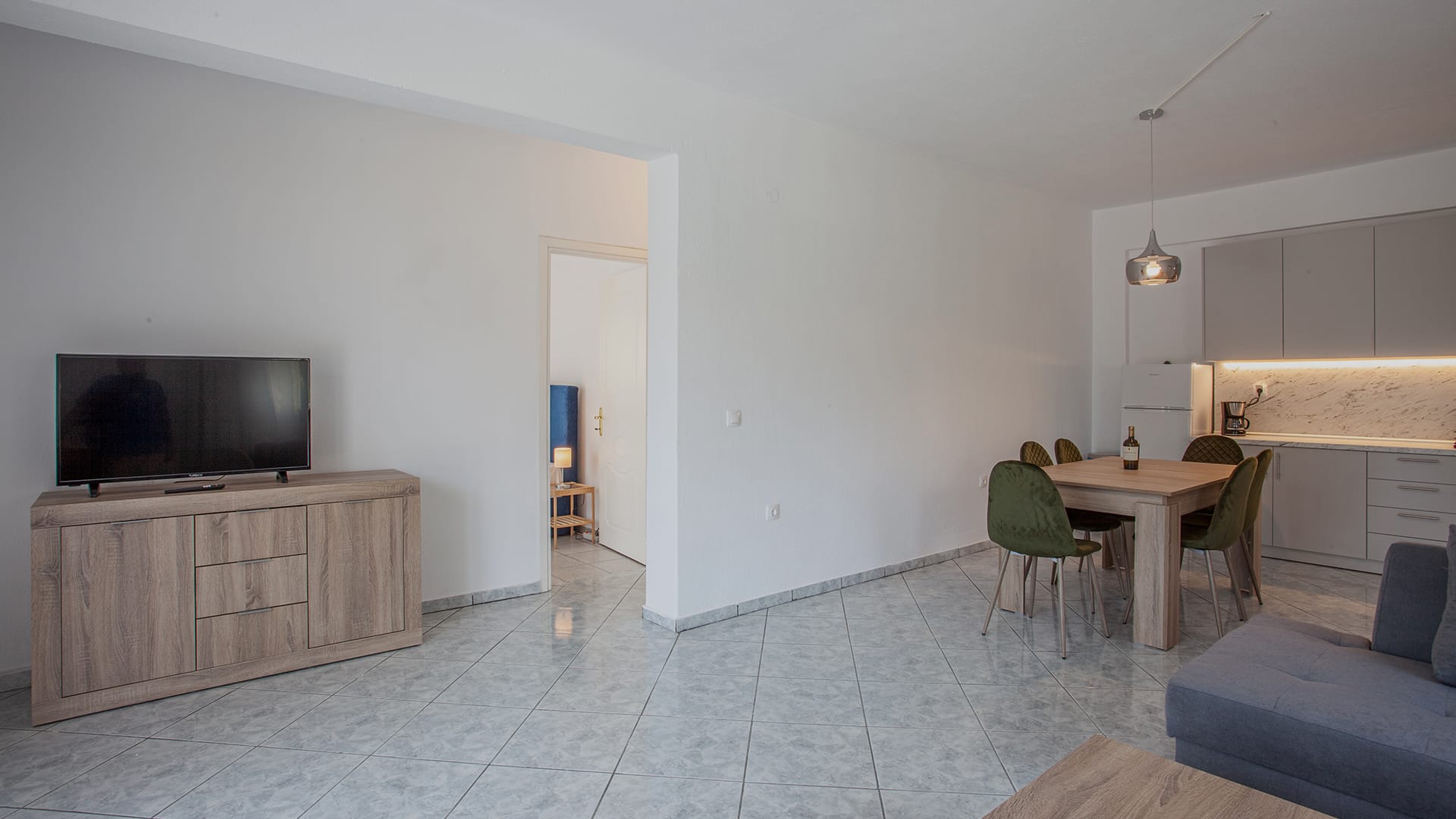 a room with a tv and chairs