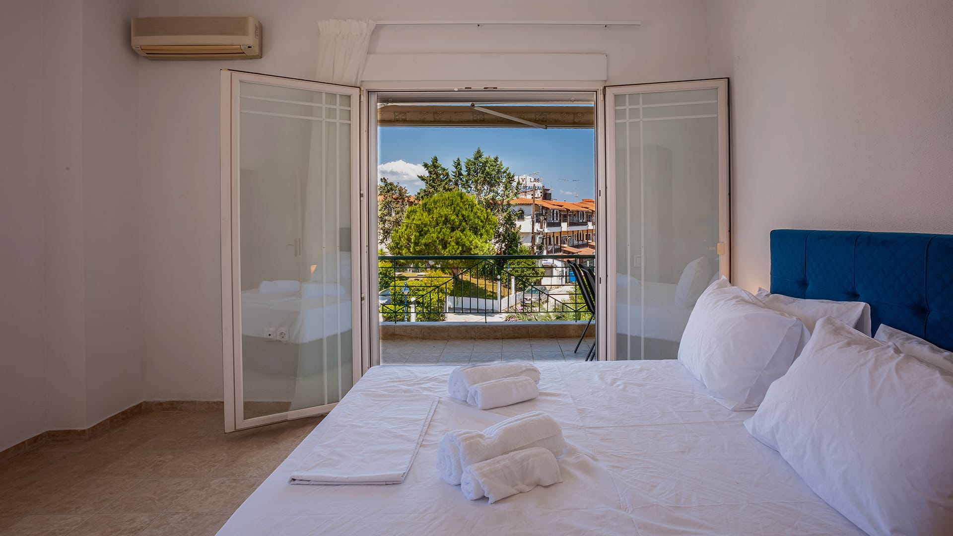 a bed with white sheets and pillows