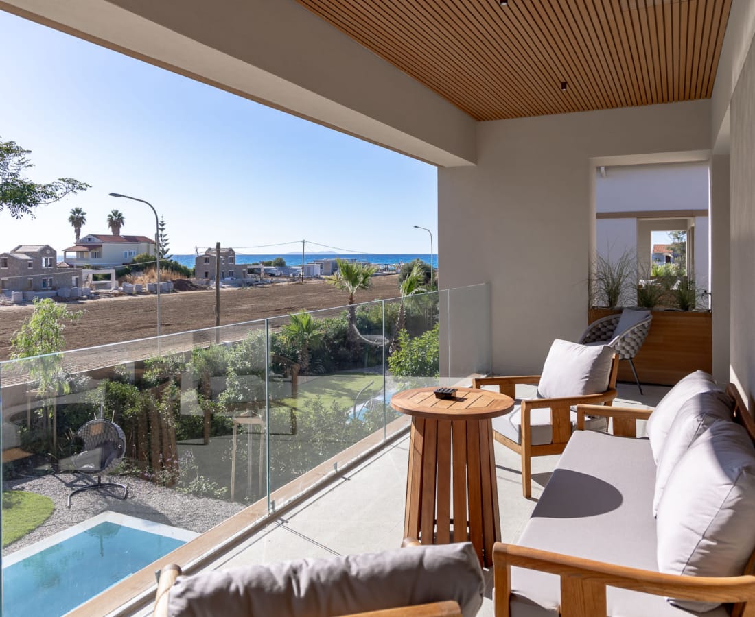 a pool and lounge chairs in a room with a large window