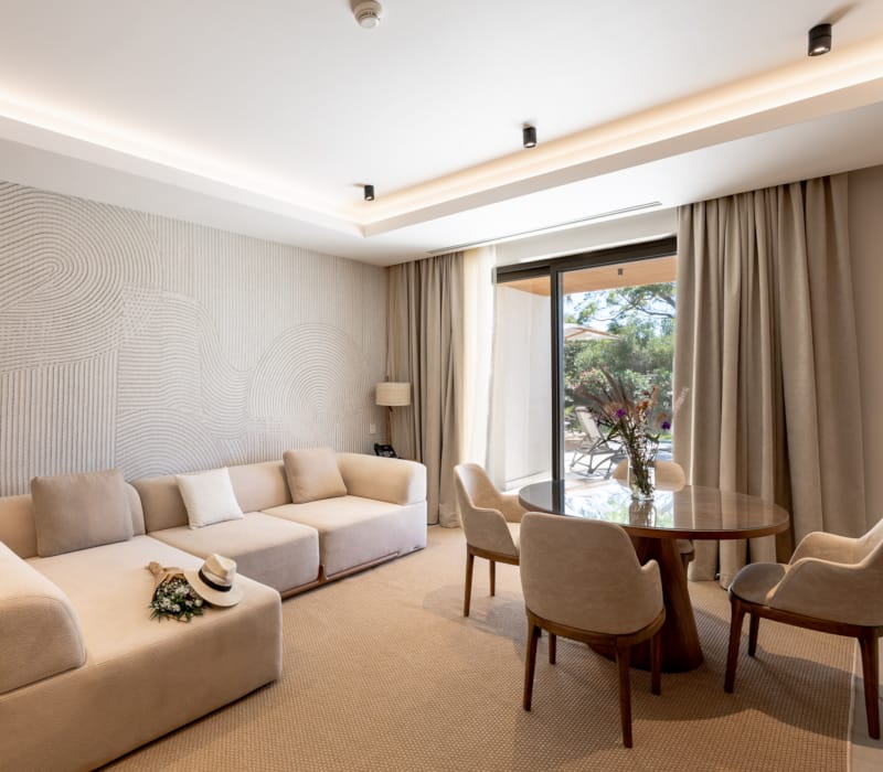 a living room with a table and chairs