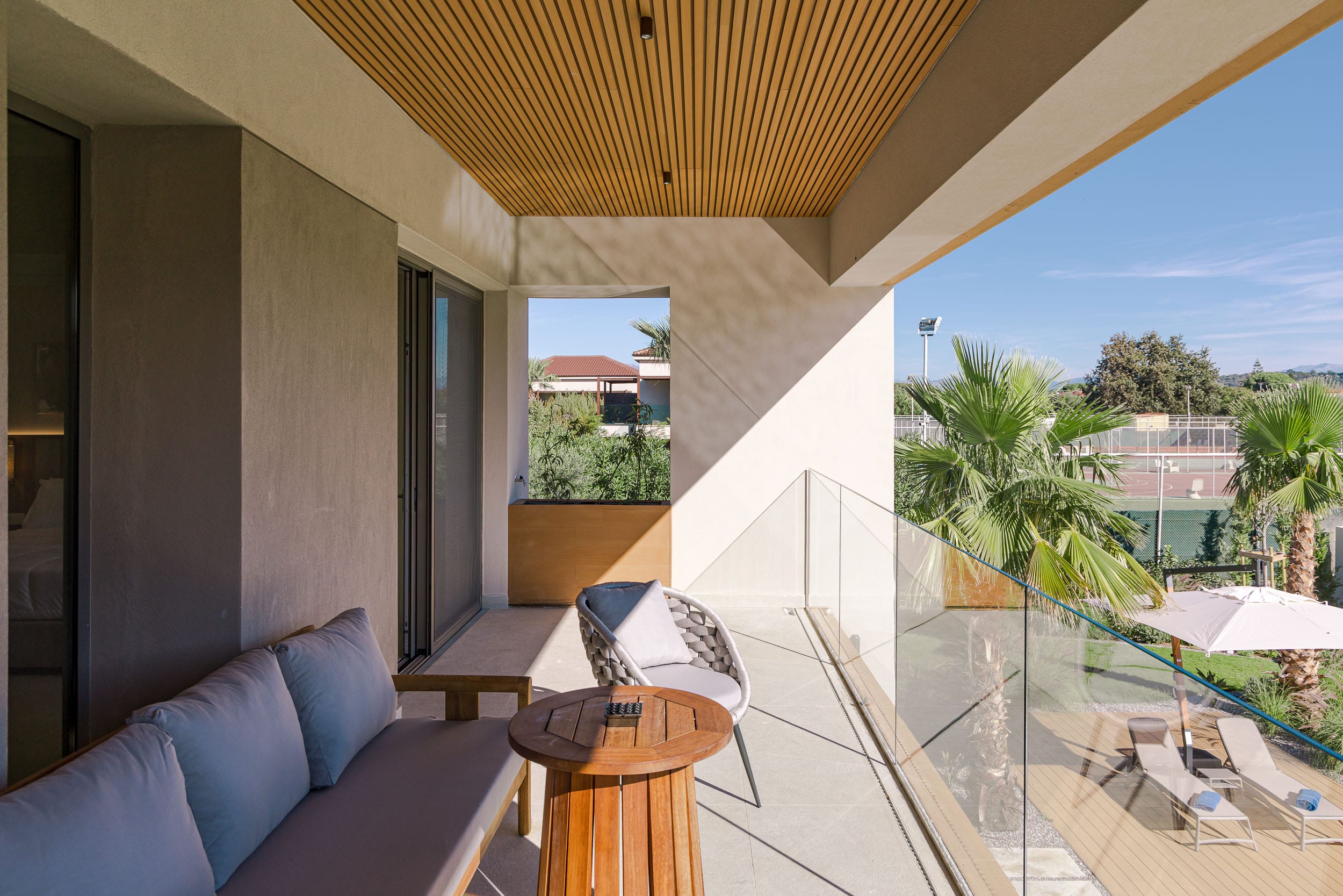 a room with a glass door and a patio with a view of the city