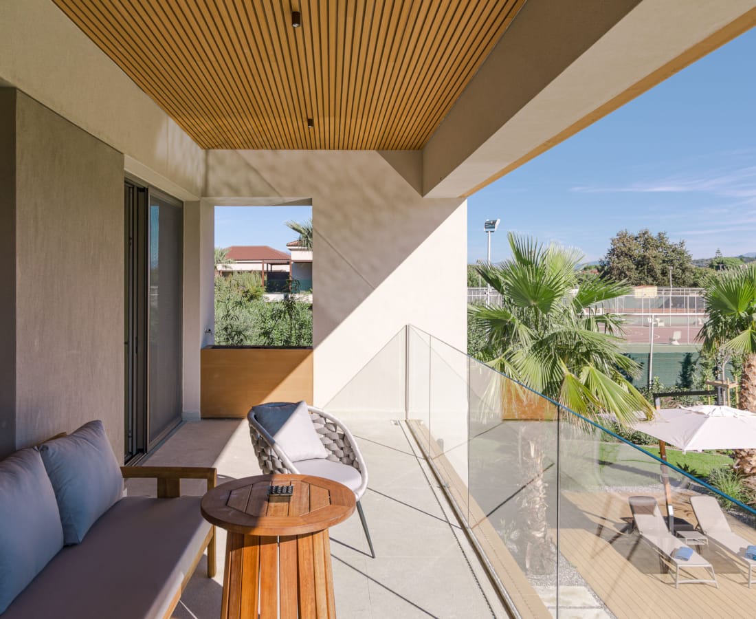 a room with a glass door and a patio with a view of the city