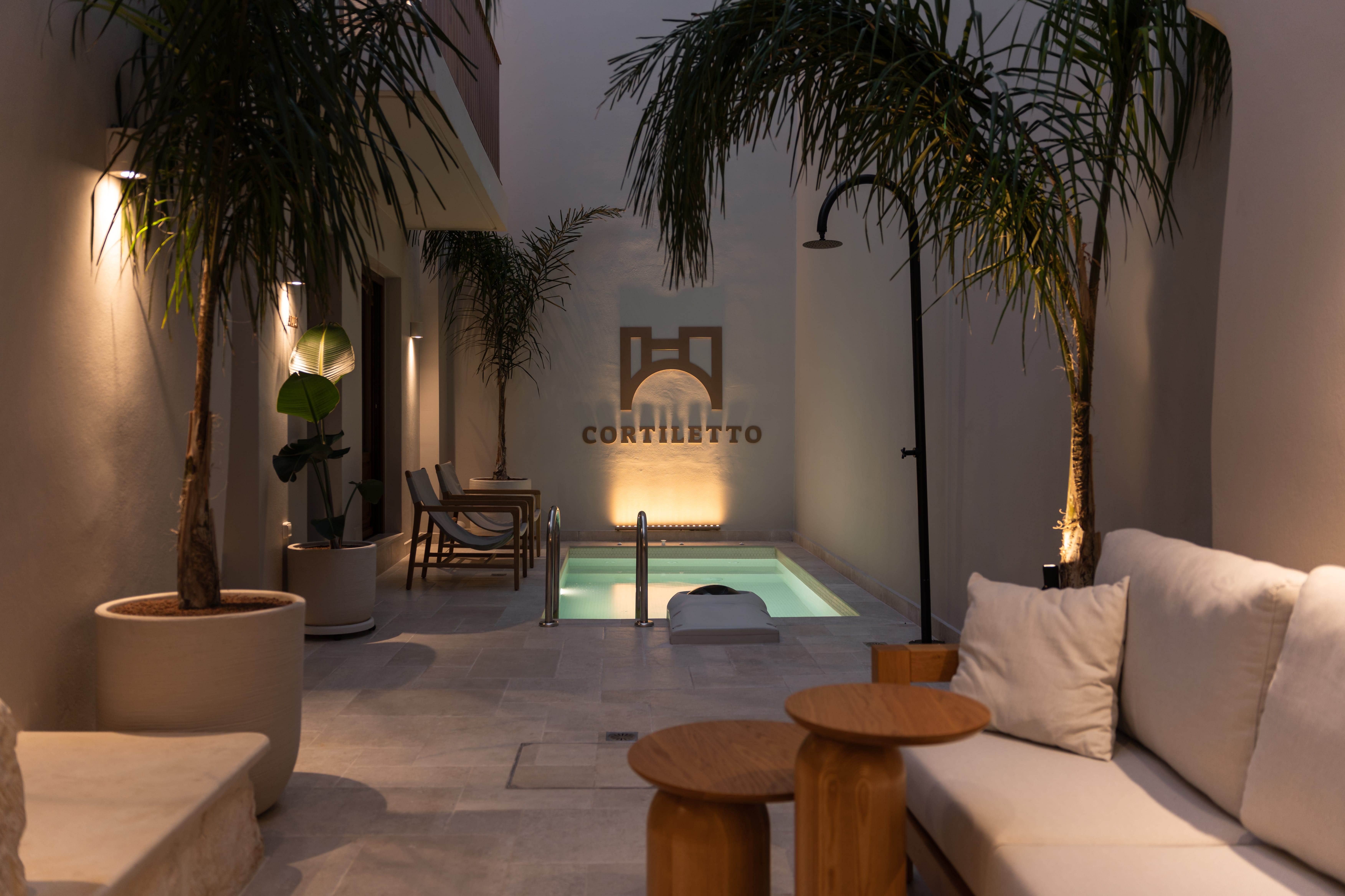 a room with palm trees and a pool