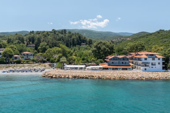 a body of water with buildings and trees around it
