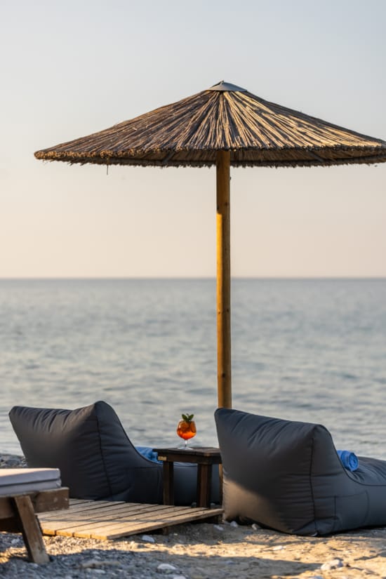 a beach with a table and umbrella