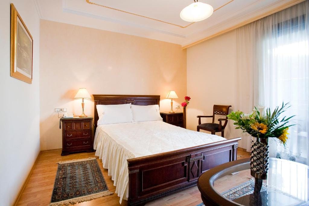 a bedroom with a bed and lamps