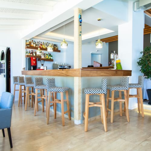 a room with a bar and chairs