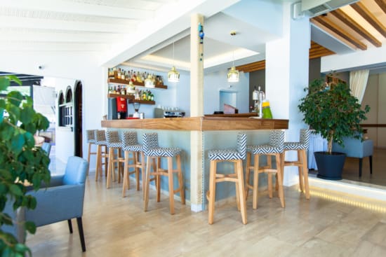 a room with a bar and chairs