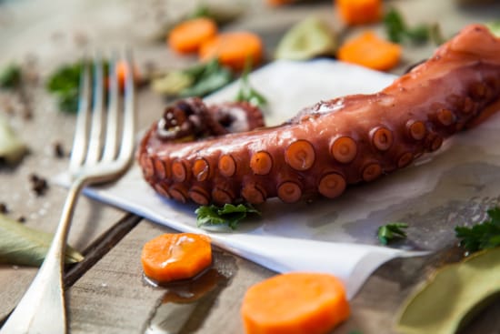 a sausage on a plate with vegetables
