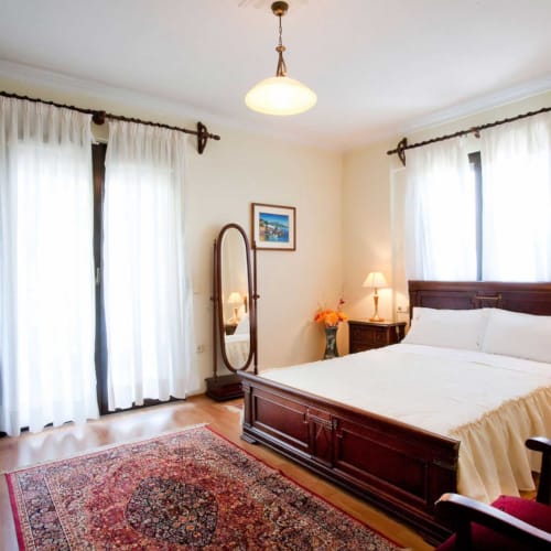 a bedroom with a bed and a mirror