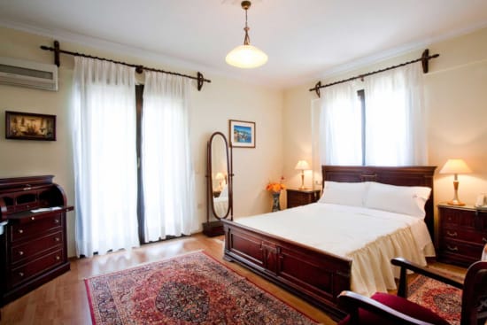 a bedroom with a bed and a mirror