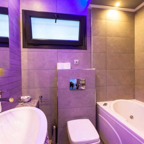 a bathroom with a tub and toilet