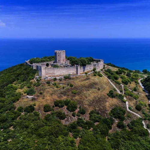 a stone castle on a hill