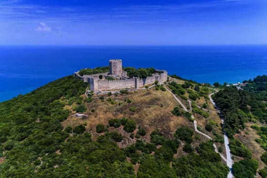 a stone castle on a hill