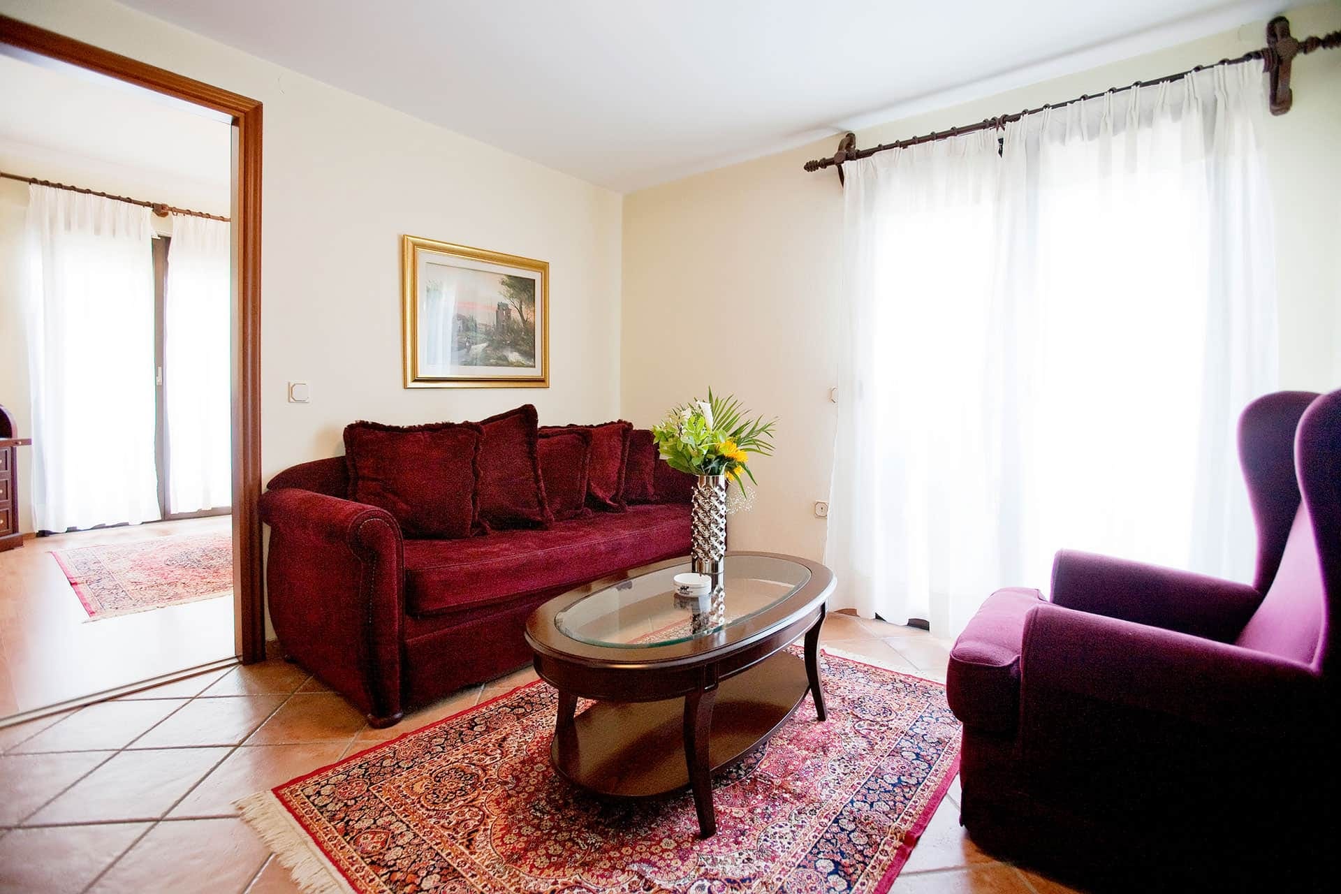 a living room with a red couch and a coffee table