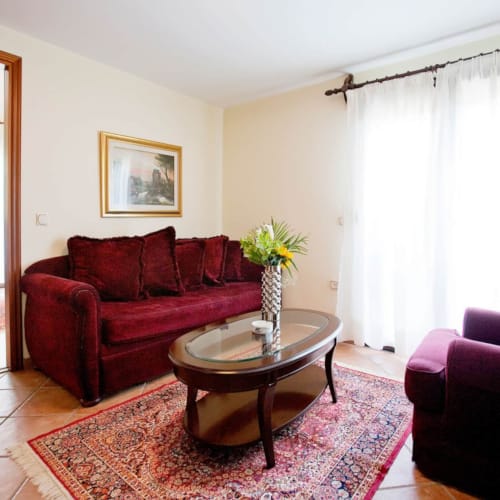 a living room with a red couch and a coffee table