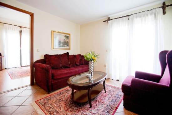 a living room with a red couch and a coffee table