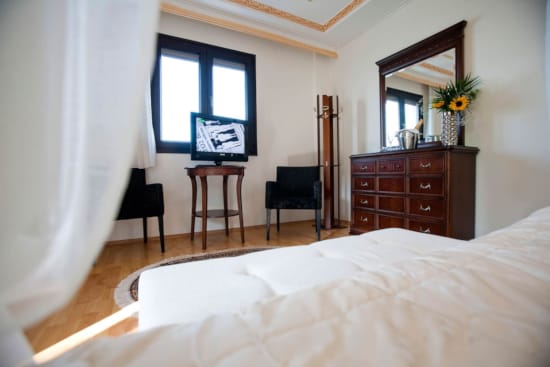 a bedroom with a bed and a desk