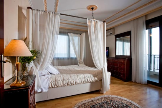 a bedroom with a bed and a lamp