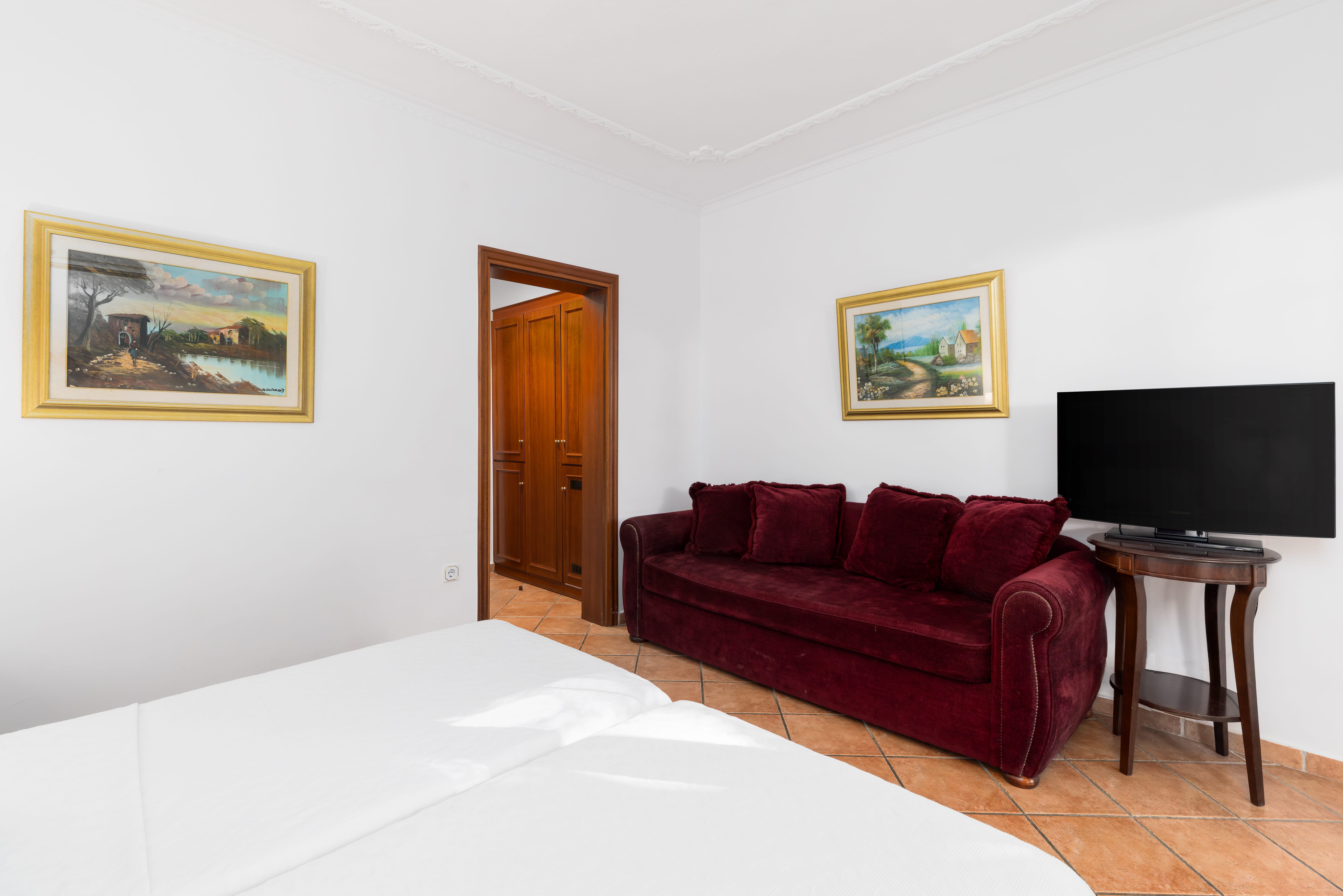 a room with a bed and a television