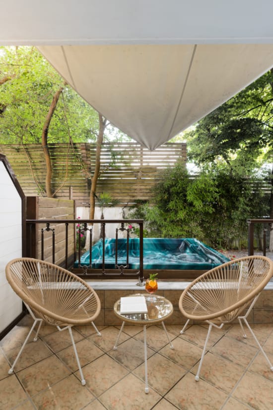 a pool and chairs on a deck