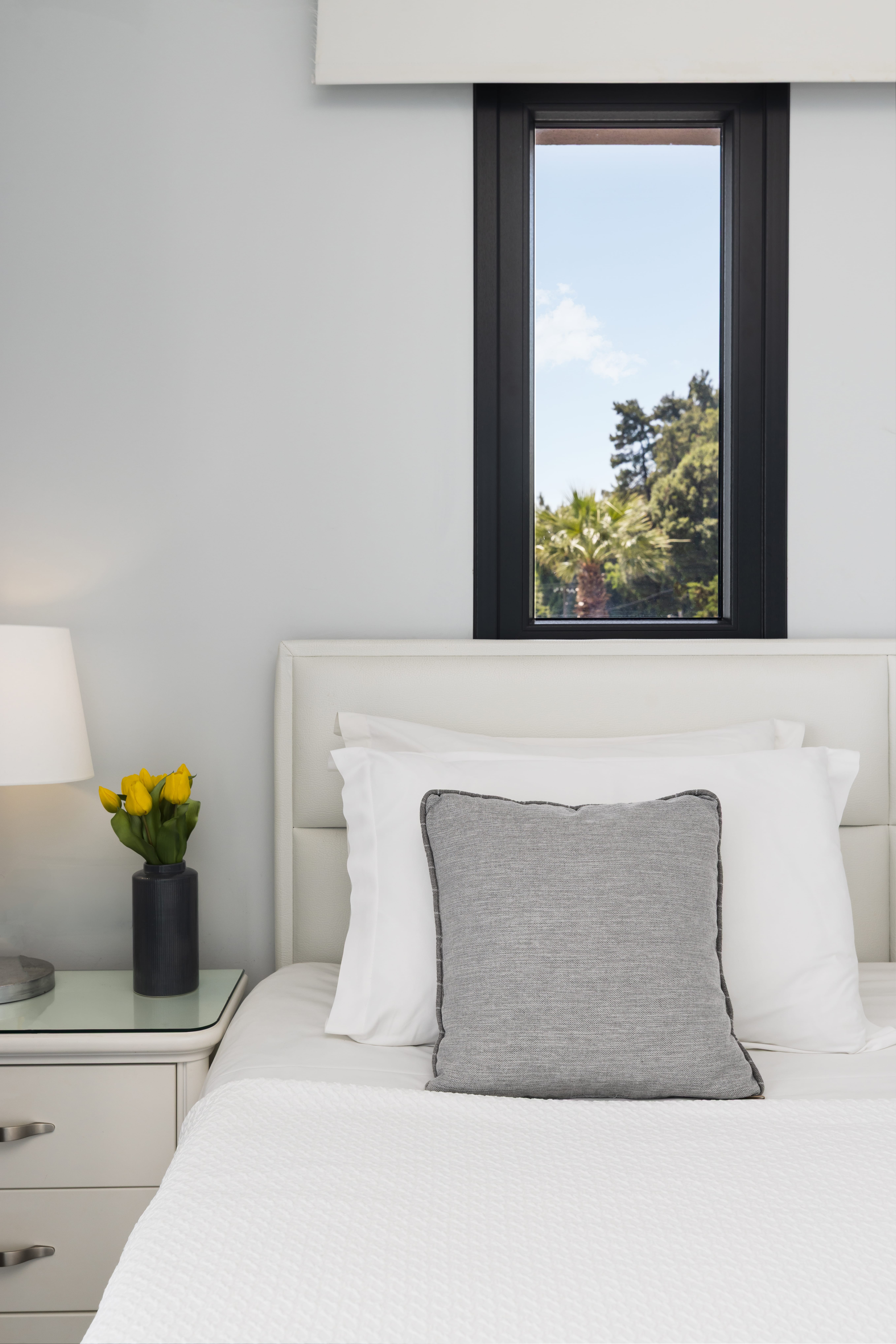 a white bed with a white pillow