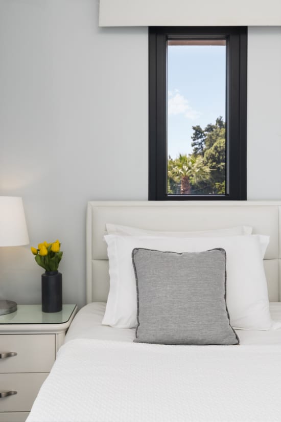 a white bed with a white pillow