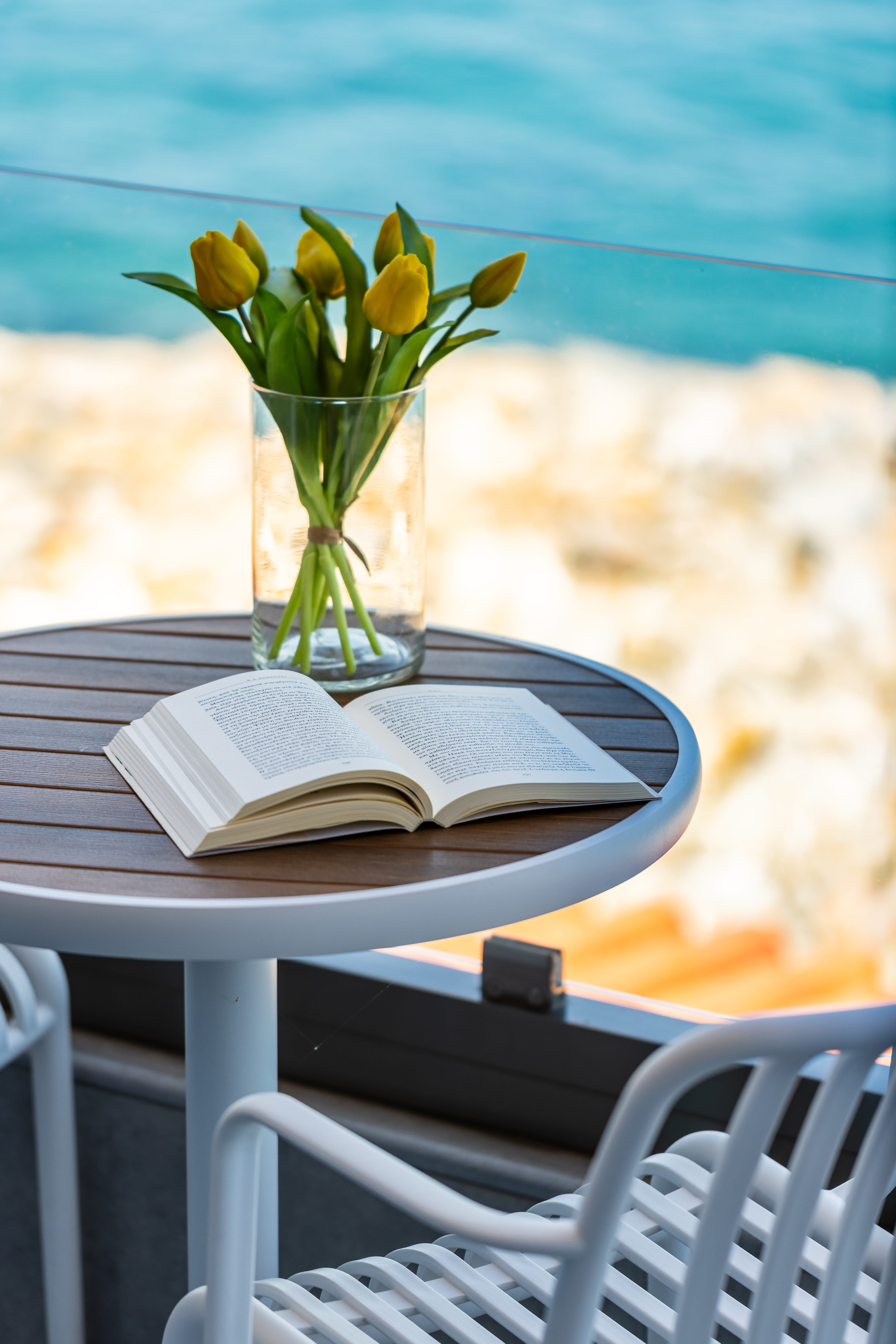 a vase of yellow flowers on a table