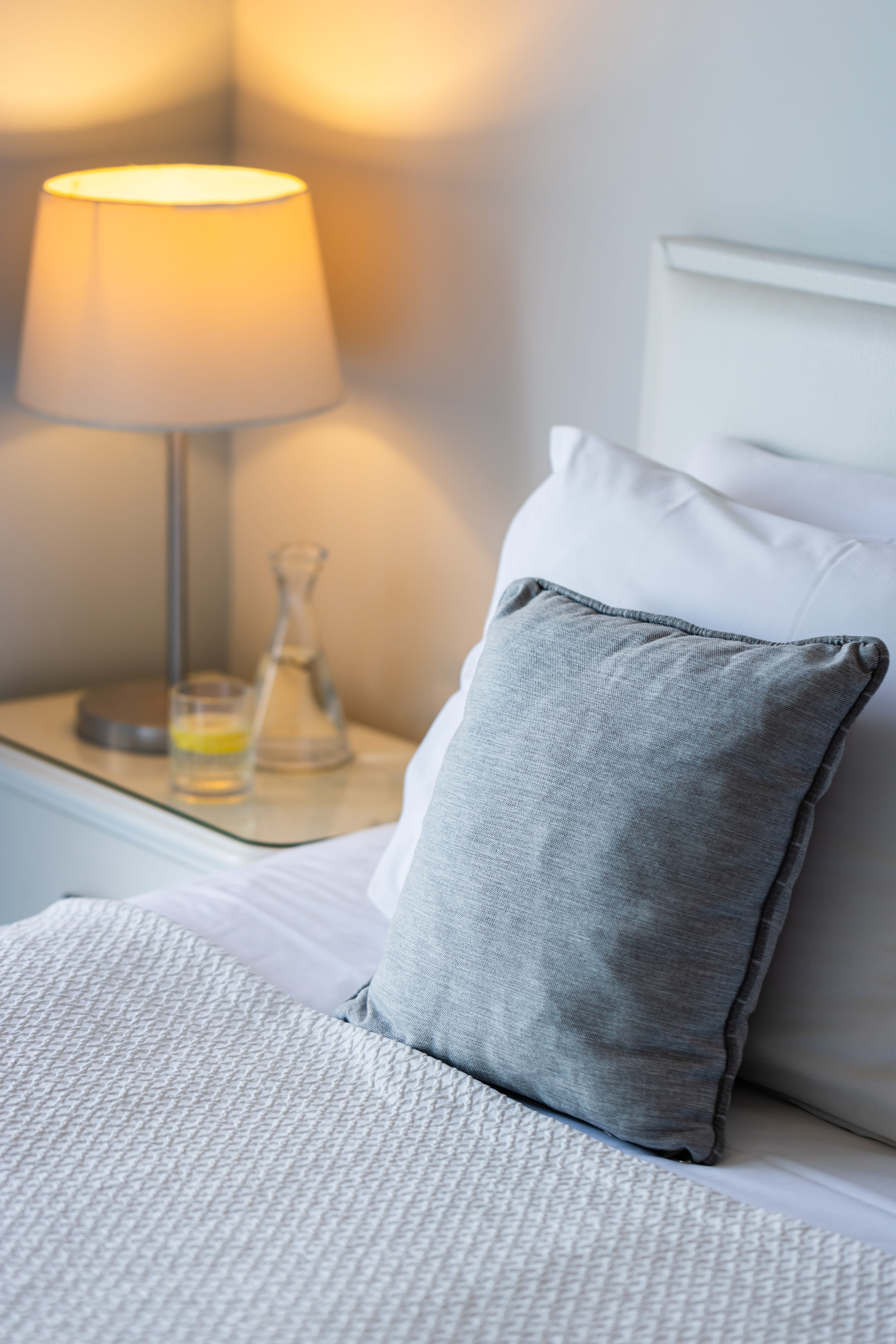 a bed with a lamp on the side